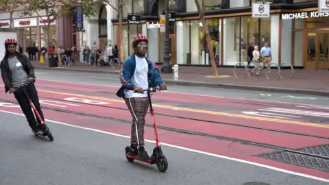 Getty Images Man riding electric scooter in San Francisco
