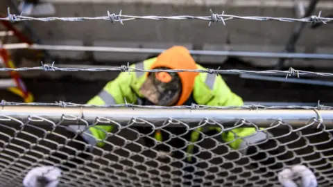 Getty Images Crews install fencing outside the Hennepin County Government Center