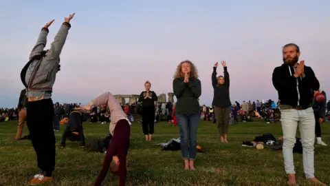 Reuters People doing Yoga at Stonehenge