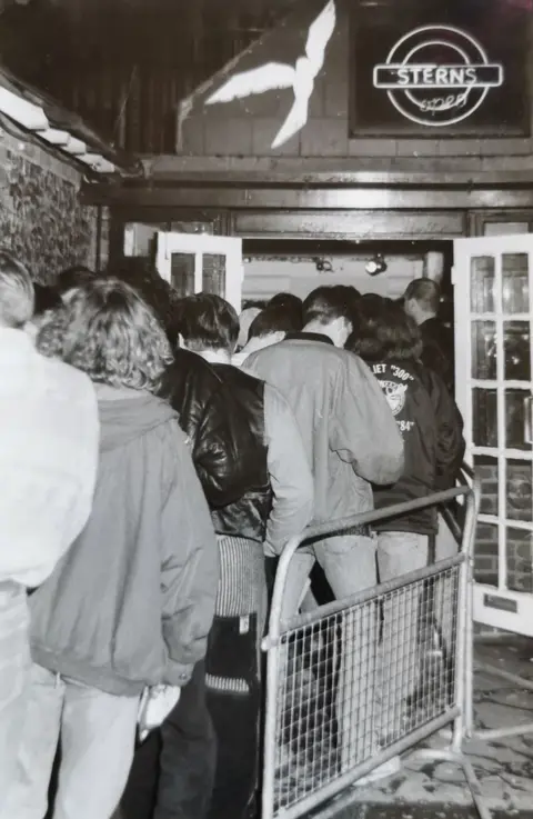 Rachel Jones Queue of people going into the club