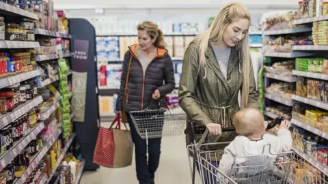 Getty Images A mother with her baby shopping