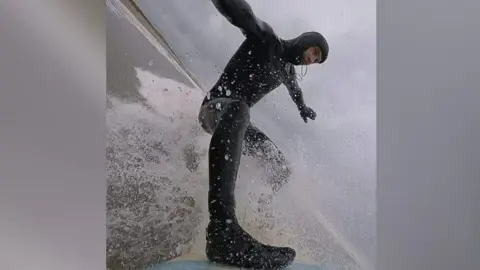 Chris Penn surfing