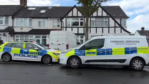 BBC Police vans outside house