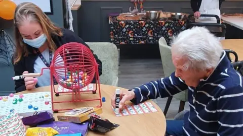 BBC A care home resident playing bingo