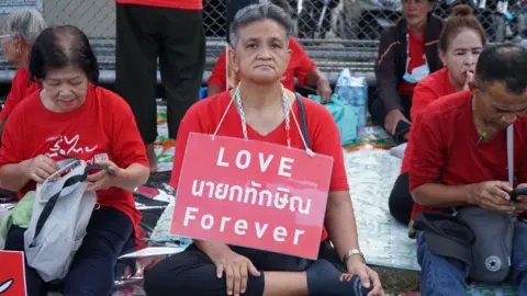 Lulu Luo/BBC  A Thaksin supporter outside the airport