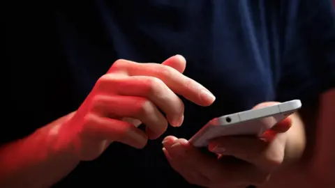 Getty Images A man on a phone
