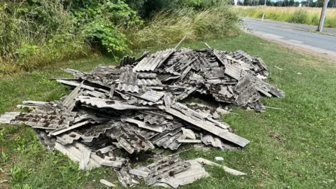 Hull City Council Pile of asbestos corrugated sheets
