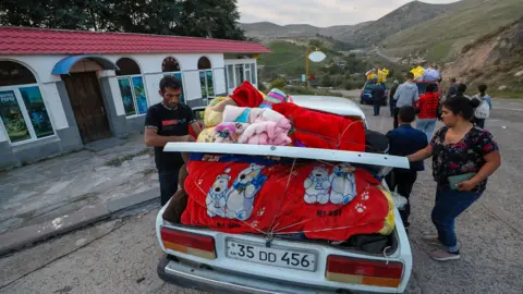 EPA Ethnic Armenians from Nagorno-Karabakh stop for a rest during their way to Goris, Armenia, on 27 September 2023.