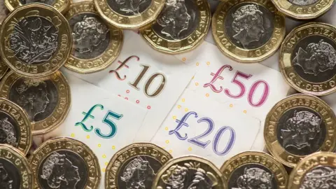 PA Media Stock photo of monetary notes and coins