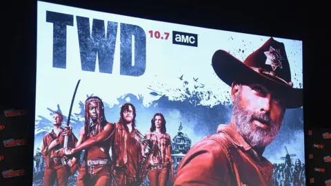 Getty Images A poster showing cast members of The Walking Dead