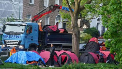 Digger removing tents from Dublin's Grand Canal 
