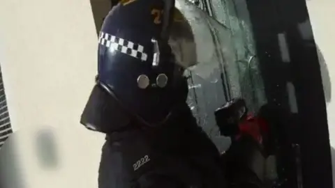 ITV/BBC Police in raid with electric saw