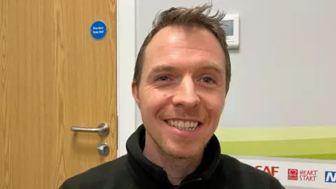 Ollie Conopo/BBC Young man with short brown hair wearing a brown fleece