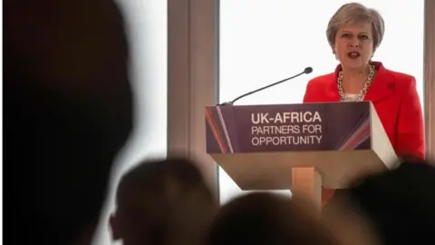 Getty Images Theresa May addressing business leaders in Cape Town