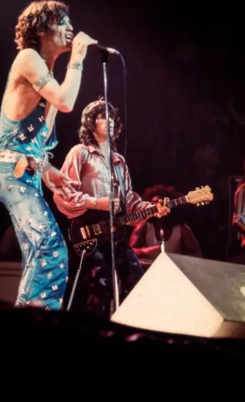 Spanish Tony Media/Bayliss Rare Books Mick Jagger and Keith Richards performing onstage in a blue jumpsuit with stars and silver shirt