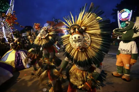 LEGNAN KOULA / EPA Dancers in costumes perform at a festival