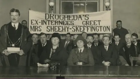 UCD Archives/EITHNE COYLE O’DONNELL PAPERS/P61/9 Eithne Coyle (seated centre right) in Cumann na mBan uniform at a reception in Dundalk in 1933