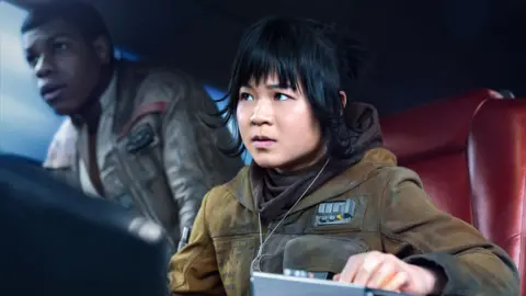 Disney/Lucasfilm Kelly Marie Tran with John Boyega in Star Wars: The Last Jedi