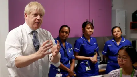 Reuters Boris Johnson with NHS staff