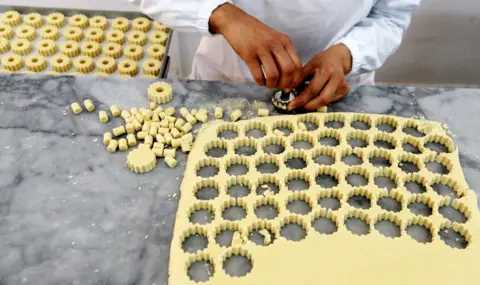 EPA Tunisian woman makes Tunisian pastry at the Masmoudi pastry factory in Sfax, Tunisia, 09 April 2022.