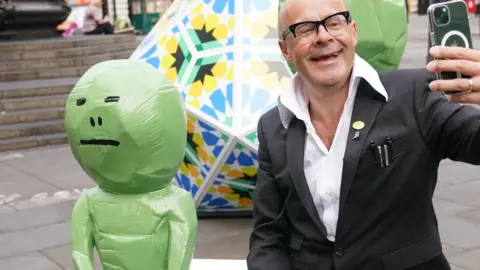 PA Media Harry Hill and an alien