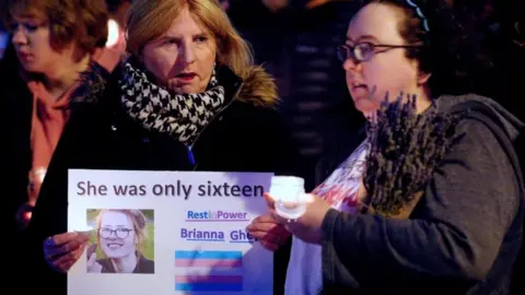 PA Media Members of the public attend a candlelit vigil at College Green in Bristol