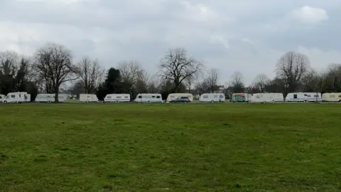 BBC Caravans and vans lining a road on the Downs in Clifton, Bristol