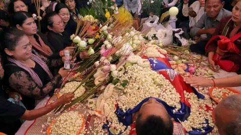 Getty Images Boeng Kak community land rights activists pay their respect to prominent political analyst Kem Ley