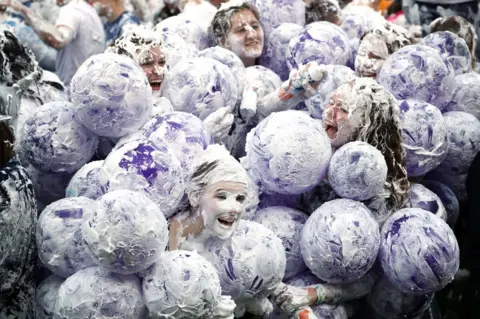 Jane Barlow / PA Hundreds of students take part in the traditional Raisin Monday foam fight on St Salvator's Lower College Lawn at the University of St Andrews in Fife