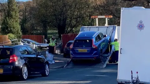 car being removed from scene by police