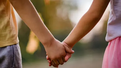 Getty Images Children holding hands