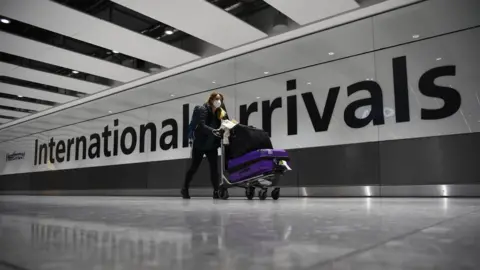 PA Media Woman arriving at Heathrow terminal 5