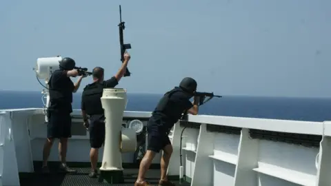 British maritime security guards "showing weapons" to ward off pirates from the bridge of a merchant tanker on an earlier voyage. It is understood there were armed guards on board the MT Mercer Street when it was attacked