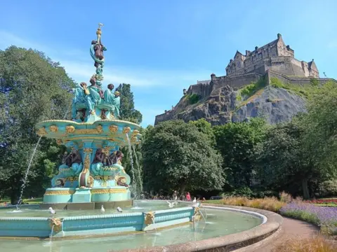 Colin Dey Ornate fountain in Princes Street Gardens with Edinburgh Castle above.