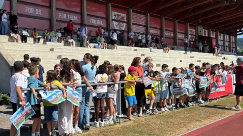 Wales were greeted by hundreds of local school children