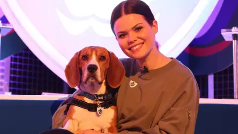 Jo Clayton/BBC Blue Peter presenter Lindsey Russell with beagle-basset hound cross Henry