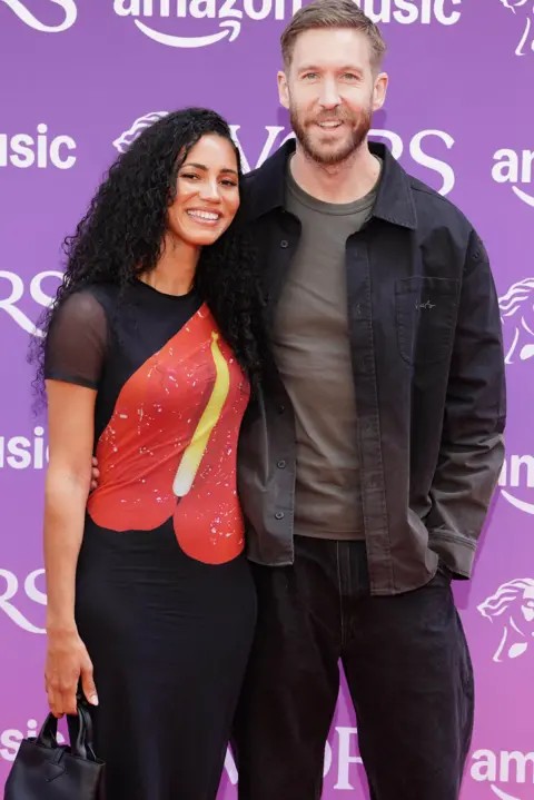PA Calvin Harris alongside his partner, presenter Vick Hope, on the red carpet before the awards