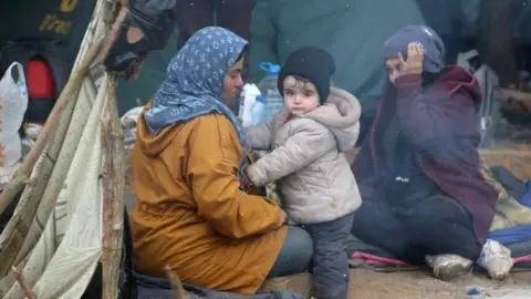 Reuters People gather in a makeshift camp on the Belarusian-Polish border in the Grodno region