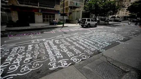 EPA Outlines of the human body and victims" names of the two-month long protests are painted on a street in of Los Palos Grandes, east of Caracas, Venezuela, 04 June 2017.