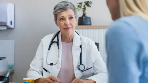 Getty Images A GP with a patient