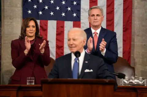 Getty Images President Joe Biden delivers the State of the Union address as Vice-President Kamala Harris and House Speaker Kevin McCarthy stand behind him