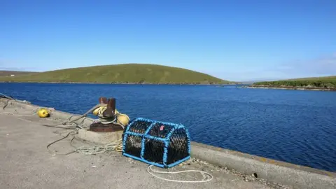 Des Blenkinsopp/Geograph Mid Yell Voe from the pier