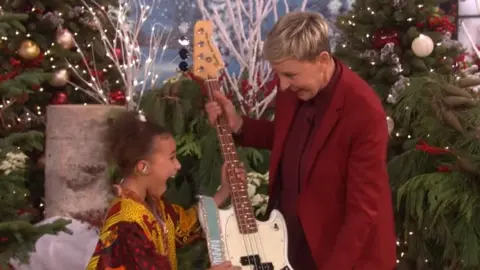 The Ellen Show Nandi Bushell looking happy when she receives the guitar from Elle DeGeneres