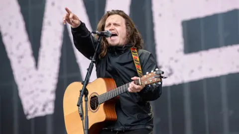 PA Media Jamie Webster performing on the main stage at the Trnsmt Festival at Glasgow Green in Glasgow, 2023
