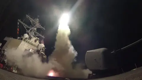 EPA Handout photo of the USS Porter launching a missile strike in the Mediterranean (7 April 2017)