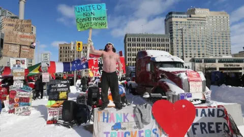 A protester makes his stand on Wellington Street as police begin to remove the "Freedom Convoy" in Ottawa from in front of Parliament Hill and surrounding streets after blockading the the downtown core of Canada's capitol for over three weeks. in Ottawa. February 18, 2022. The Freedom or Truckers Convoy is protesting a variety of mandates and measures that were put in place to slow the spread of COVID-19.