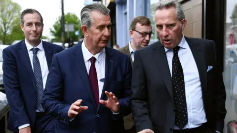 Reuters Edwin Poots (red tie) talks to MP Ian Paisley outside DUP headquarters on Friday