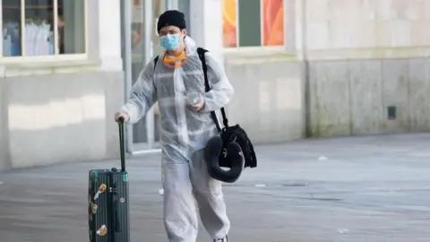 Getty Images Man in forensic suit at train station