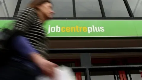 PA A woman walking past job centre plus