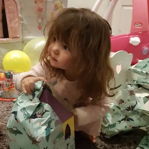 Stephanie Lack Abigail opening her presents